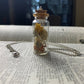 Rodent Bone And Flower Bottle Charm Necklace