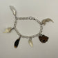 Oddity Charm Bracelet with Rodent Mandible, Butterfly Wings, Python Vertebra, and Seashell